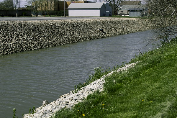 A canal with sloped gravel banks
